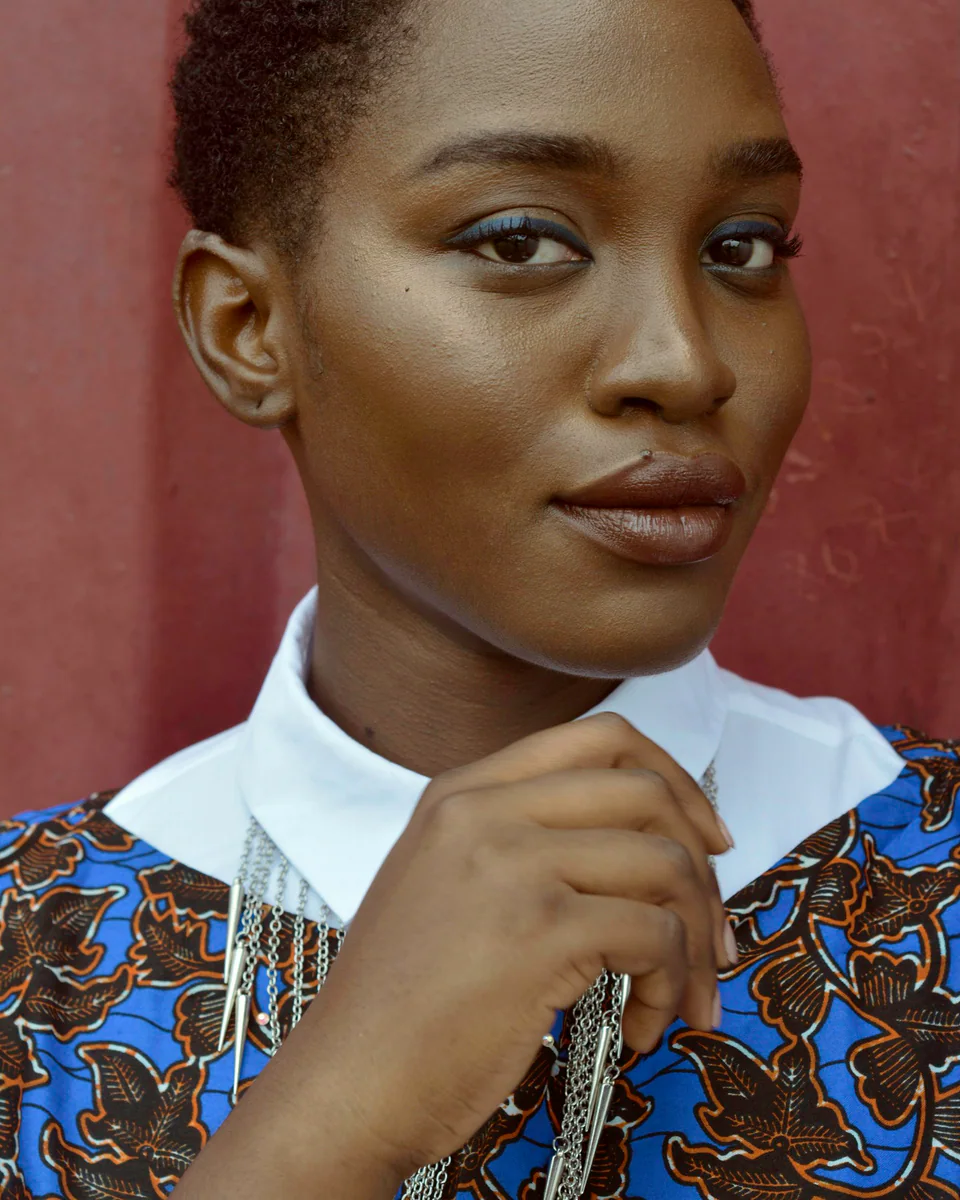 Poised companion in a tailored outfit against a warm backdrop